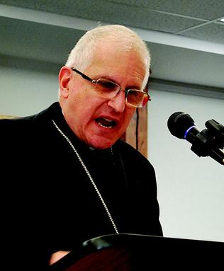 Bp. Martino of Scranton rolls up his sleeves