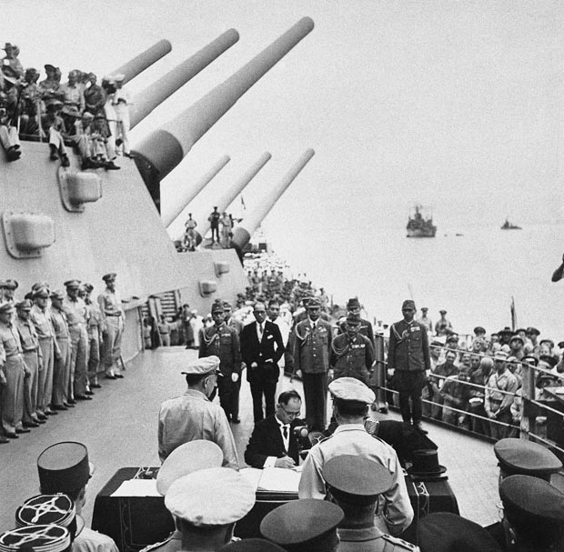Japanese Foreign Minister Mamoru Shigemitsu sign Japanese Instrument of Surrender, a  document  signed on the deck of the USS Missouri in Tokyo Bay on Sept. 2 1945 in Japan. (AP Photo/pool/Life)